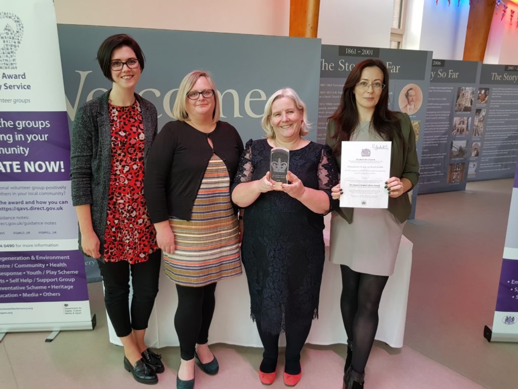 A group of our fabulous volunteers collect our Queen’s Award for Voluntary Service