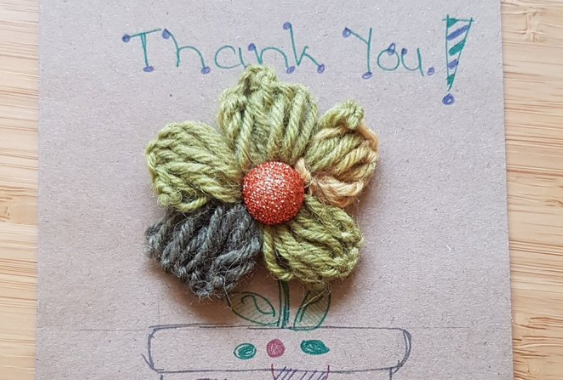 Hand crafted thank you message with woollen flower